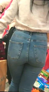 Skinny brunette with a nice booty in line in tight jeans
