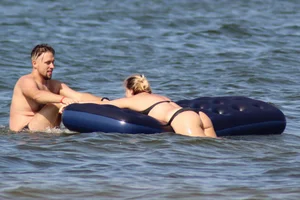 Black thong bikini blonde with a nice ass out on a tube in the water