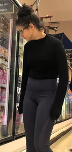 Girl with glasses shopping in leggings showing her VPL