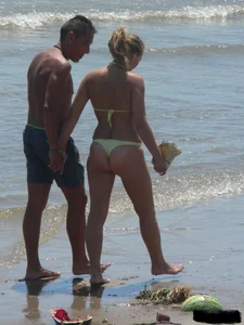 Sexy blonde on the beach in a yellow thong bikini
