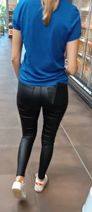 German Girl with shiny leather Jeans Ass in supermarket