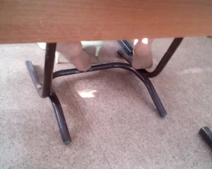 Feet in Pantyhose With High-Heeled Shoes Taken Off Under Desk Creepshot