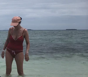 Milf at the beach in a red swimsuit with a nice body