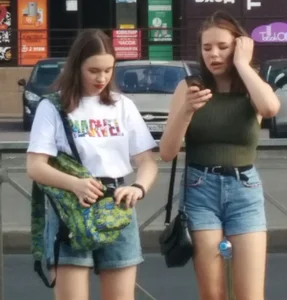 Couple of cute and sexy candid girls wearing shorts on the street