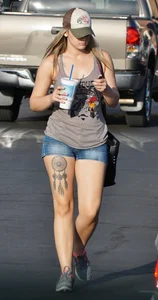 Hot blonde after shopping in short jean shorts and tank top