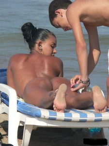 Hot ass topless beach girl with great tits lets her little brother oil up her ass in thong bikini