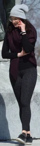 Brunette with glasses on the phone in tight patterned leggings