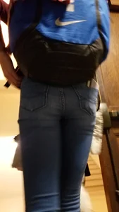 Blonde student in jeans showing her blue thong whale tail