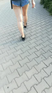 Girl walking in denim shorts showing some of her ass cheeks