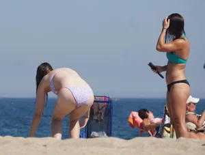 2 cute friends in bikinis on the beach