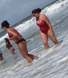 Fat chick on the beach in a red swimsuit