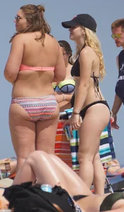 Two thick white girls in bikinis on the beach with big asses