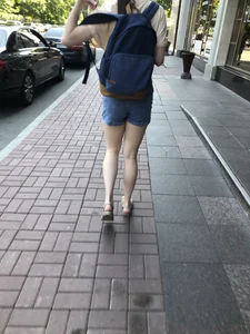 Girl with awesome pale legs in shorts wearing a backpack street creepshots