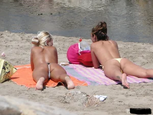 Tattooed blonde with big tits topless and in thong