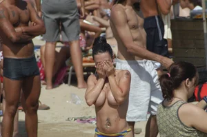 Topless girls on a beach in Barcelona