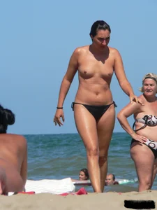 Bunch of sexy babes on the beach topless and in thong bikinis
