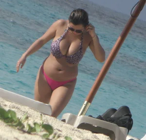 Lady with big tits wearing pink thong on the beach