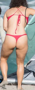 Thick brunette milf on the beach in red thong bikini
