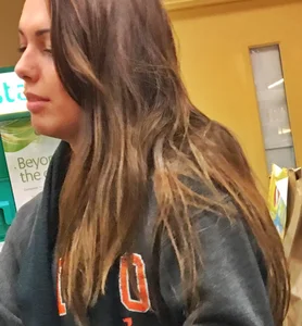 Fit shopping brunette girl in leggings and a hoodie with a nice ass
