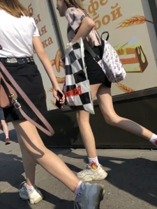 Couple of Skinny Girls in Mini-Skirts And Sneakers Street Photos