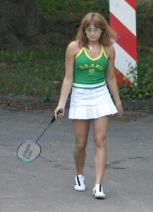 Pretty girl playing tennis in a skirt and walking in jeans