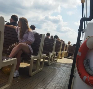 An Amazingly Hot Candid Girl in a Short Dress Sitting on a Bench on a Boat With Crossed Legs Creepshots Series