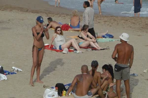 Topless girls on a beach in Barcelona