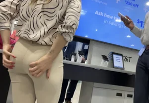 Plus Face shot - Gorgeous AT&T babe in beige pants  touching her ass with long red nails