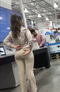 Plus Face shot - Gorgeous AT&T babe in beige pants  touching her ass with long red nails