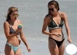 2 sexy babes on the beach in thong bikinis