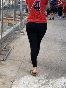 Bunch of girls in various outfits at a Cardinals baseball game