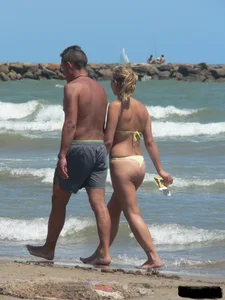 Sexy blonde on the beach in a yellow thong bikini