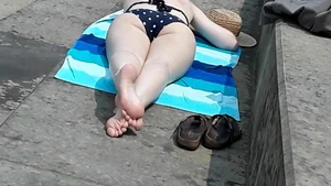 Chubby Milf In a Swimsuit Lying on Her Stomach With Crossed Legs Creepshot