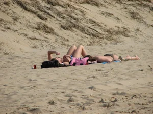 Topless beach girl with nice titties with her friend in a bikini
