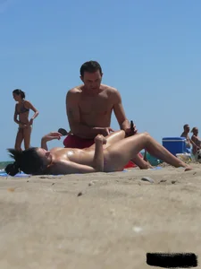 Purple thong topless lady on the beach gets oiled up by her husband