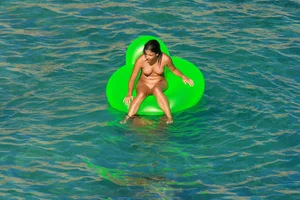 FKK Nudists playing in the water with floater