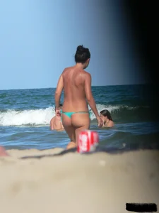 Bunch of sexy babes on the beach topless and in thong bikinis