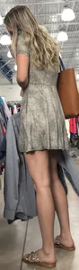 Basic blonde in a dress shopping for her man