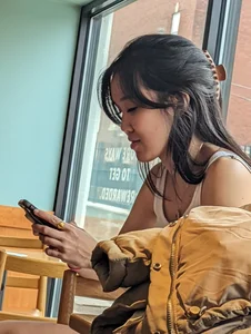 Slender asian teen oblivious at the cafe