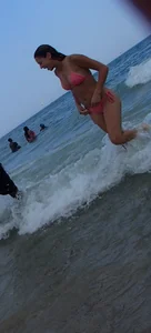 Pierced nipples hottie in pink at the beach