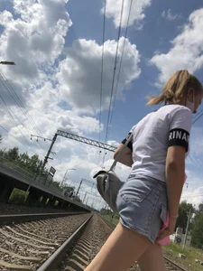 Cute Girl in Denim Shorts Walking Down a Railway Station Gallery