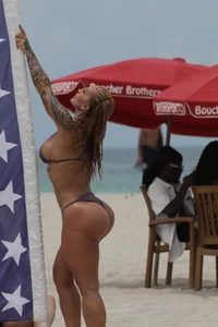 Big boobed and big assed tattood sexy chick on the beach