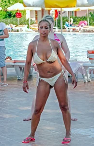 Big boobed blonde milf dancing by the pool in a bikini