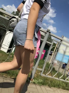 Cute Girl in Denim Shorts Walking Down a Railway Station Gallery