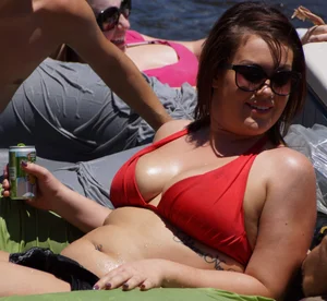 Sexy party girls in bikinis on a lake