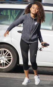 Beautiful black girl in Nike leggings in the parking lot