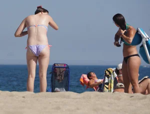 2 cute friends in bikinis on the beach