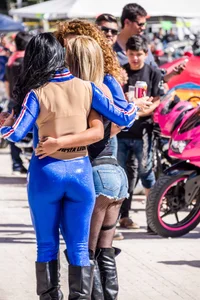 Sexy car models in tight shiny blue legging type pants