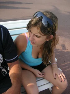 Girl leaning over to show off her nice tits while sitting on a bench