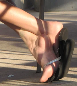 Lady in flop flops while eating showing her feet